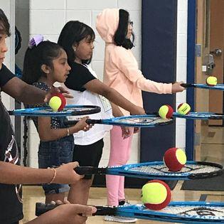 Kids holding tennis rackets